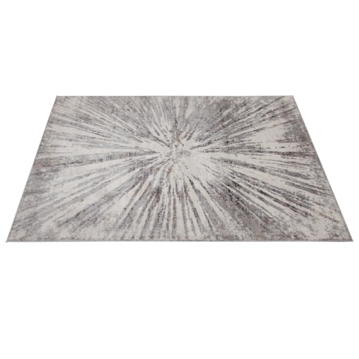 Tappeto moderno con motivo astratto a stella nei toni del grigio e bianco.