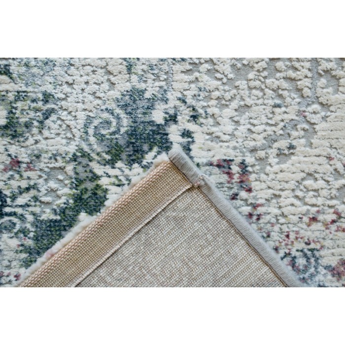 Tappeto moderno con motivo floreale in verde, grigio e beige.