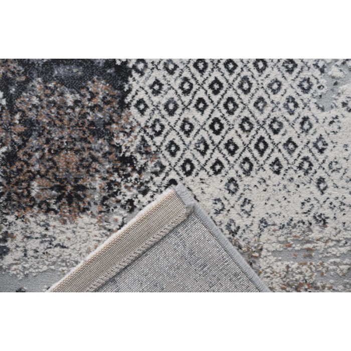 Tappeto moderno con motivo astratto in grigio, nero e bianco.