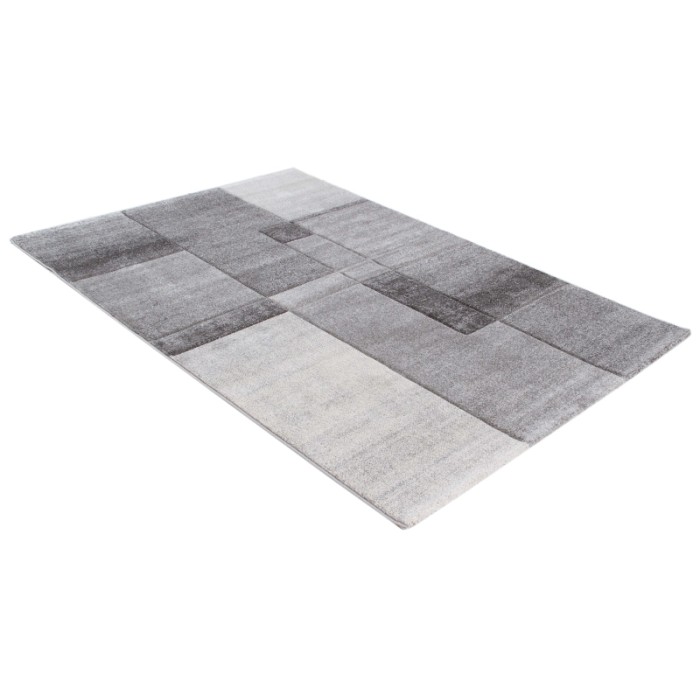 Tappeto moderno con motivo geometrico nei toni del grigio e bianco.