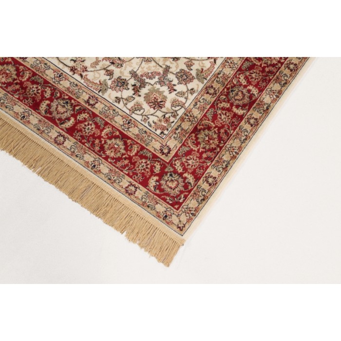Dettaglio di un tappeto moderno con motivo floreale in rosso e beige.