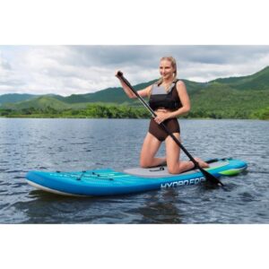 Donna su tavola SUP Bestway Aqua Journey blu con pagaia sull'acqua.