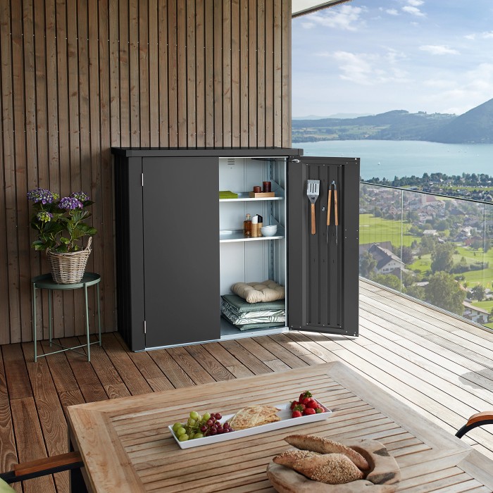 Armadio da terrazza Biohort Romeo Gr. M grigio scuro con anta aperta su una terrazza.