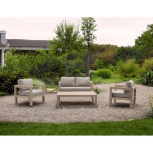 Set di mobili da giardino t.b.t. con divano, poltrone e tavolo su ghiaia.
