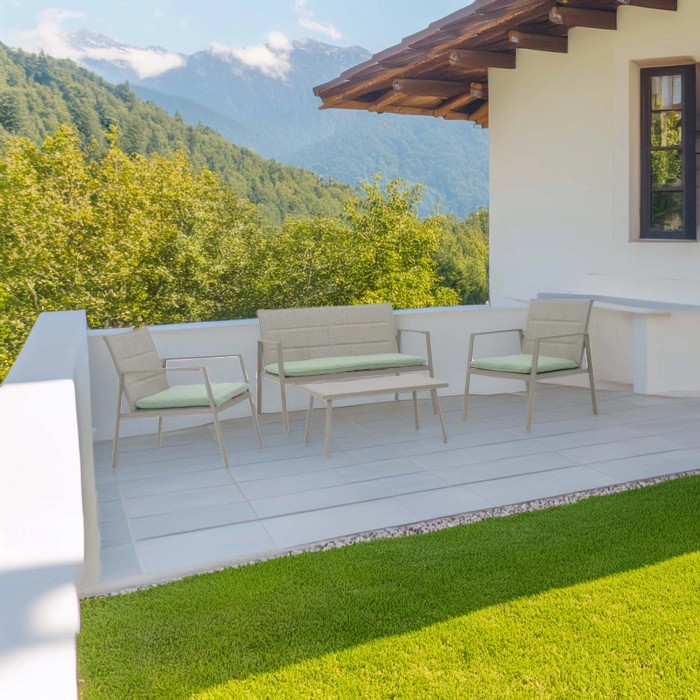 Set mobili da giardino t.b.t.: divano, due sedie e tavolo su terrazza con vista montagna.