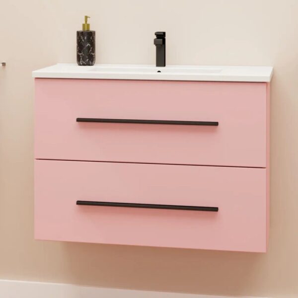 Mobile bagno rosa con due cassetti, lavabo bianco e rubinetto nero.