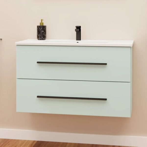 Mobile bagno sospeso verde menta con due cassetti e maniglie nere.